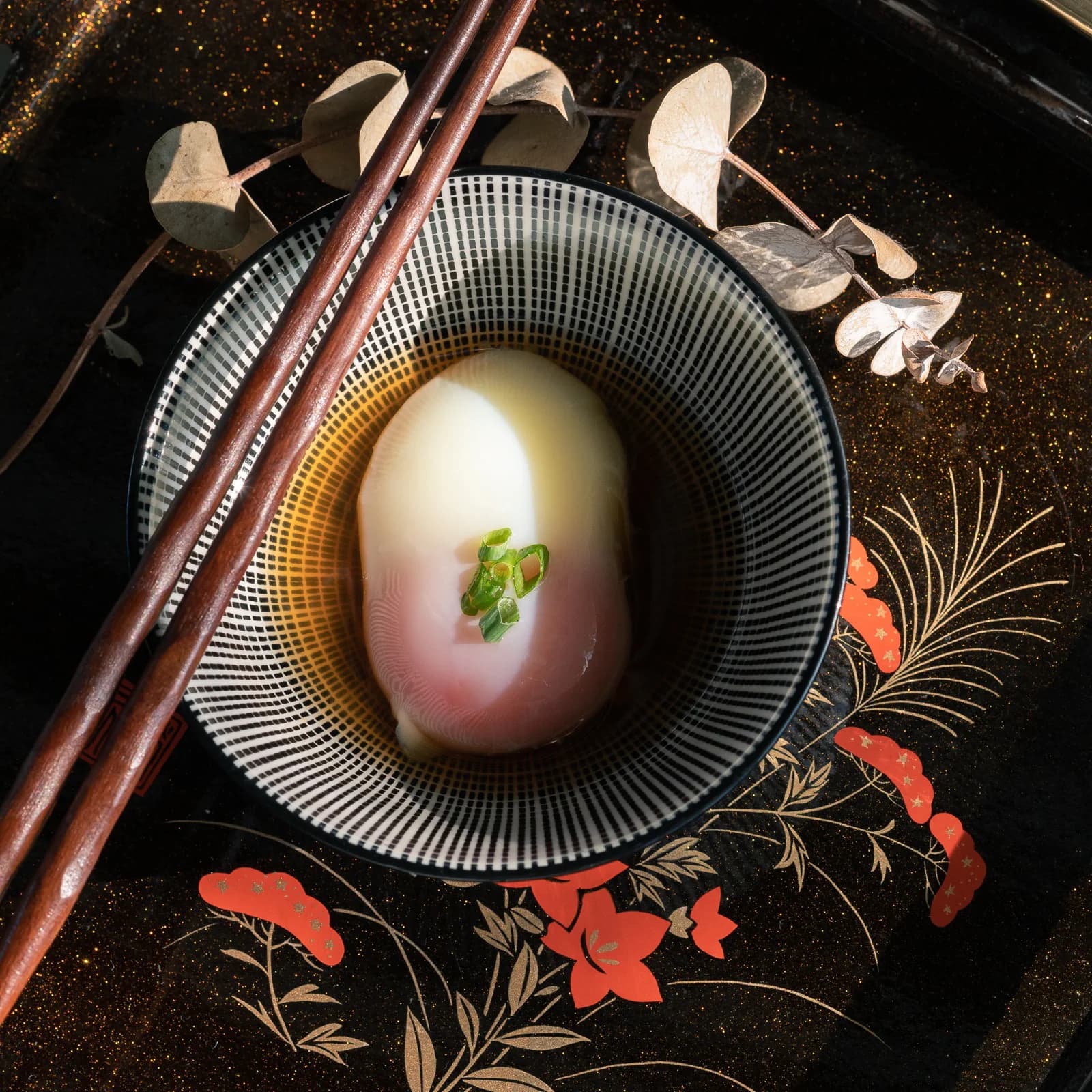 Onsen egg in dashi soy sauce on Japanese lacquerware